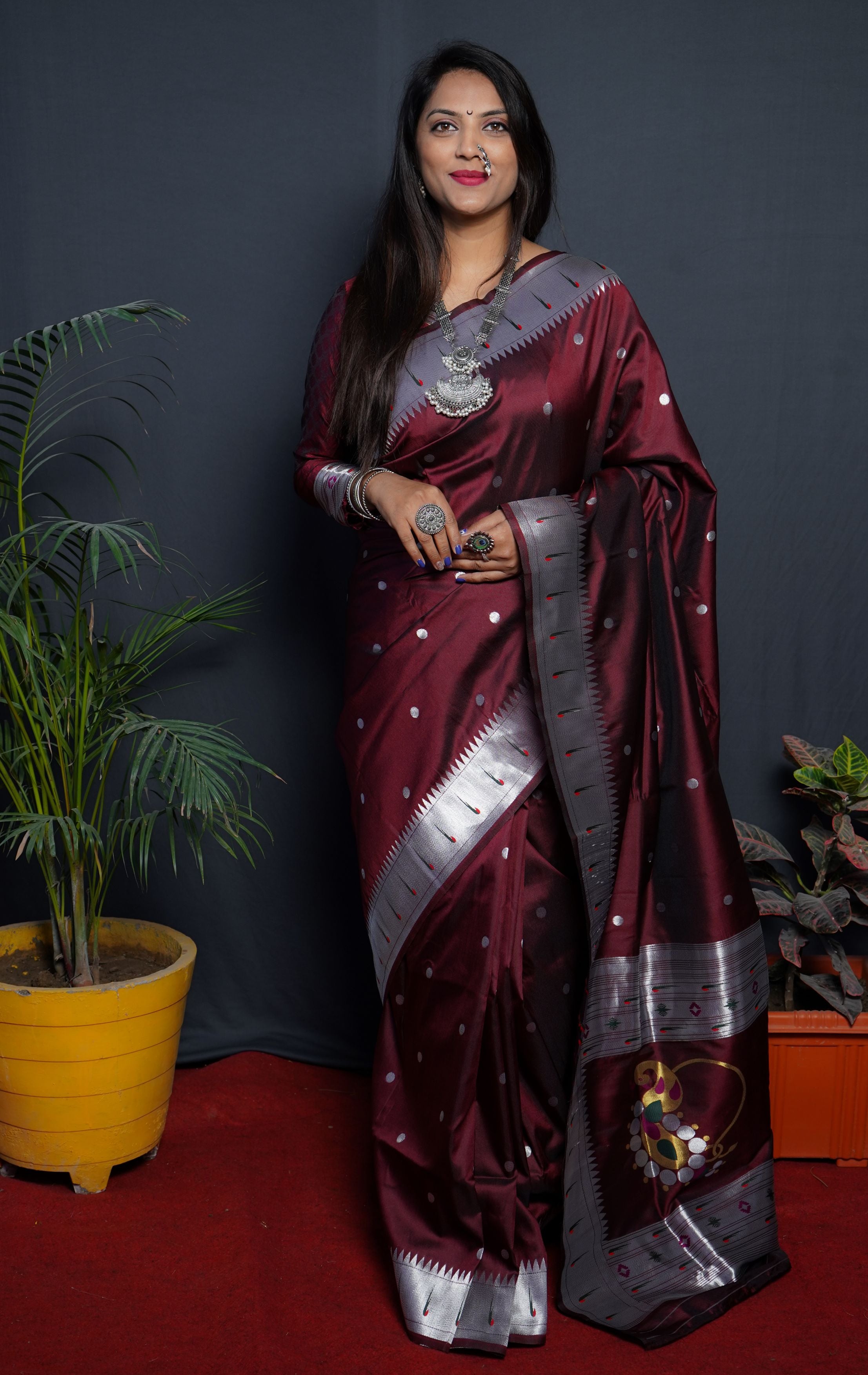 Maroon color pure paithani silk saree with muniya bodar and beautiful Silver and meenakari nath pallu and blouse pis